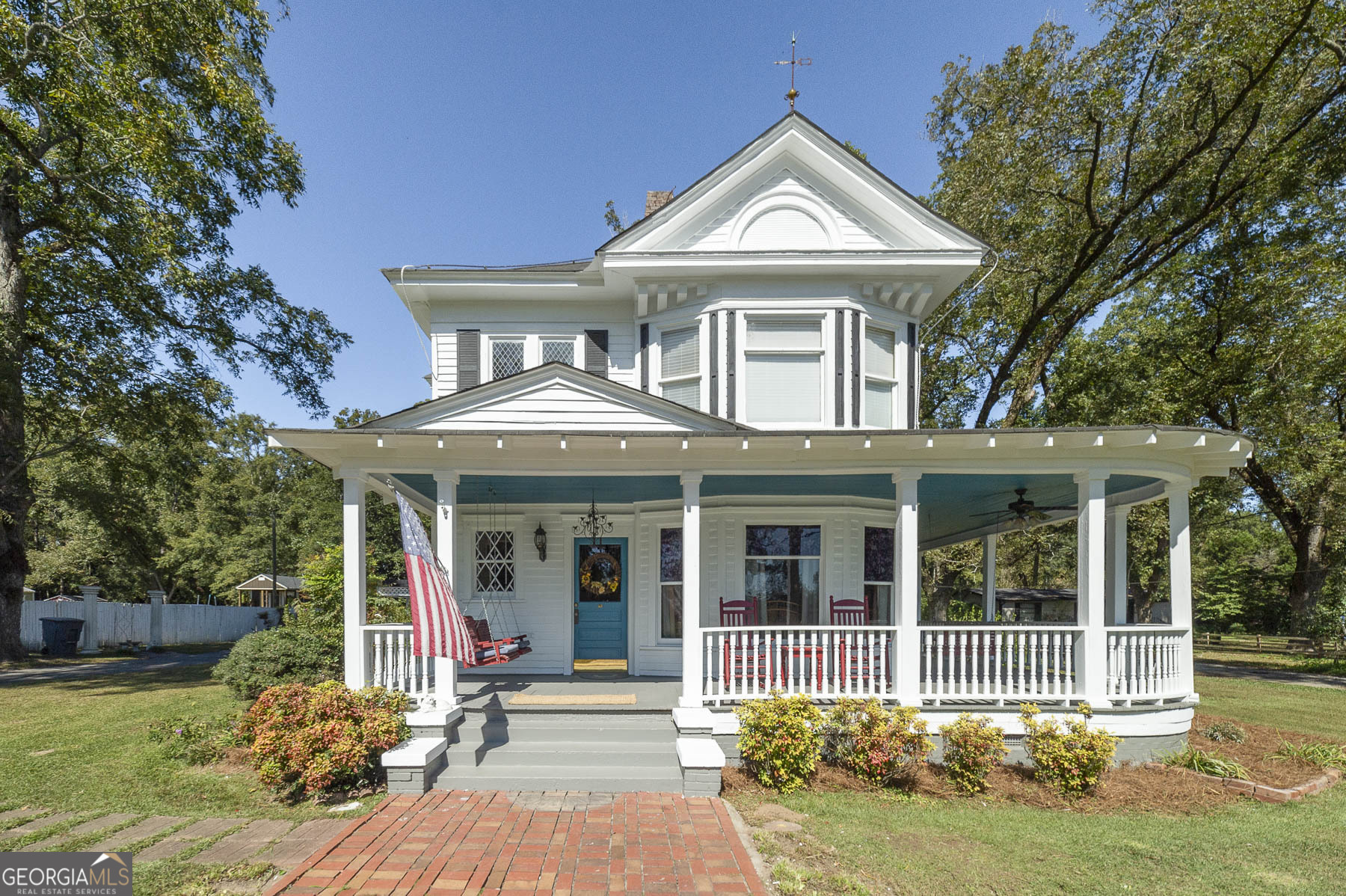 a front view of a house with a yard table and chairs