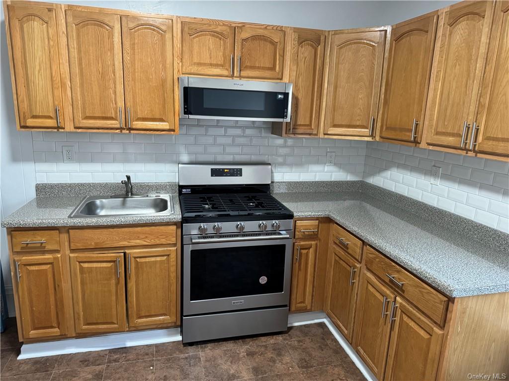 a kitchen with stainless steel appliances granite countertop white cabinets a stove top oven with wooden floor