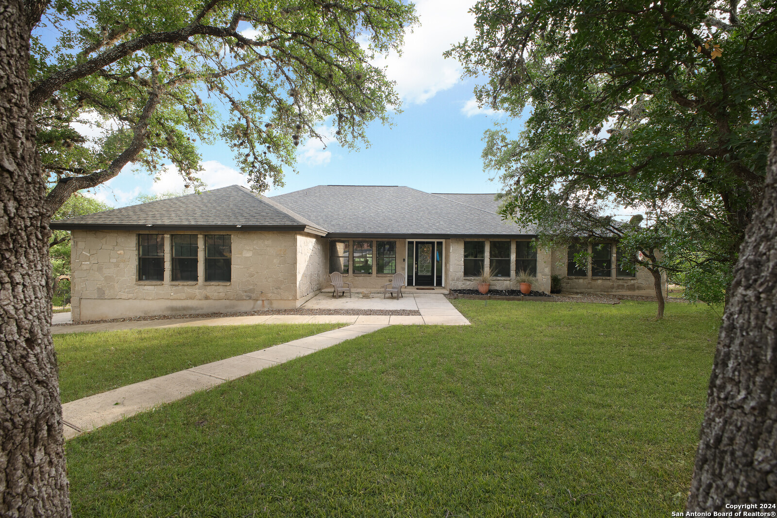 a front view of a house with a garden