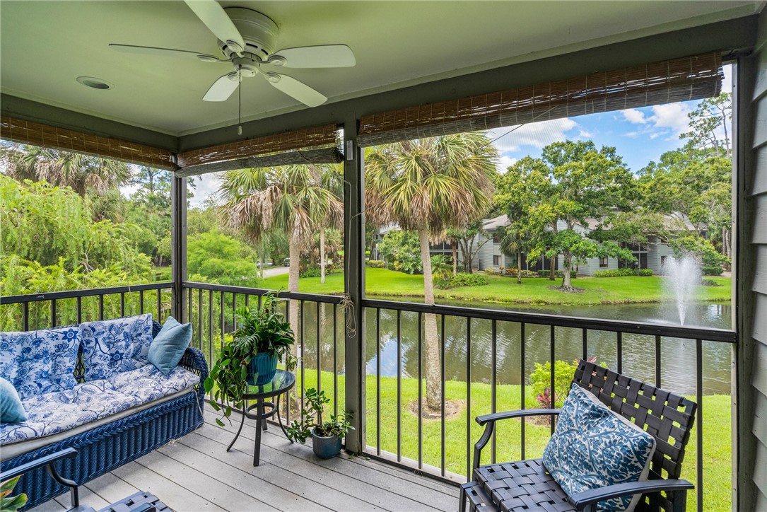 a view of a porch with furniture and a yard