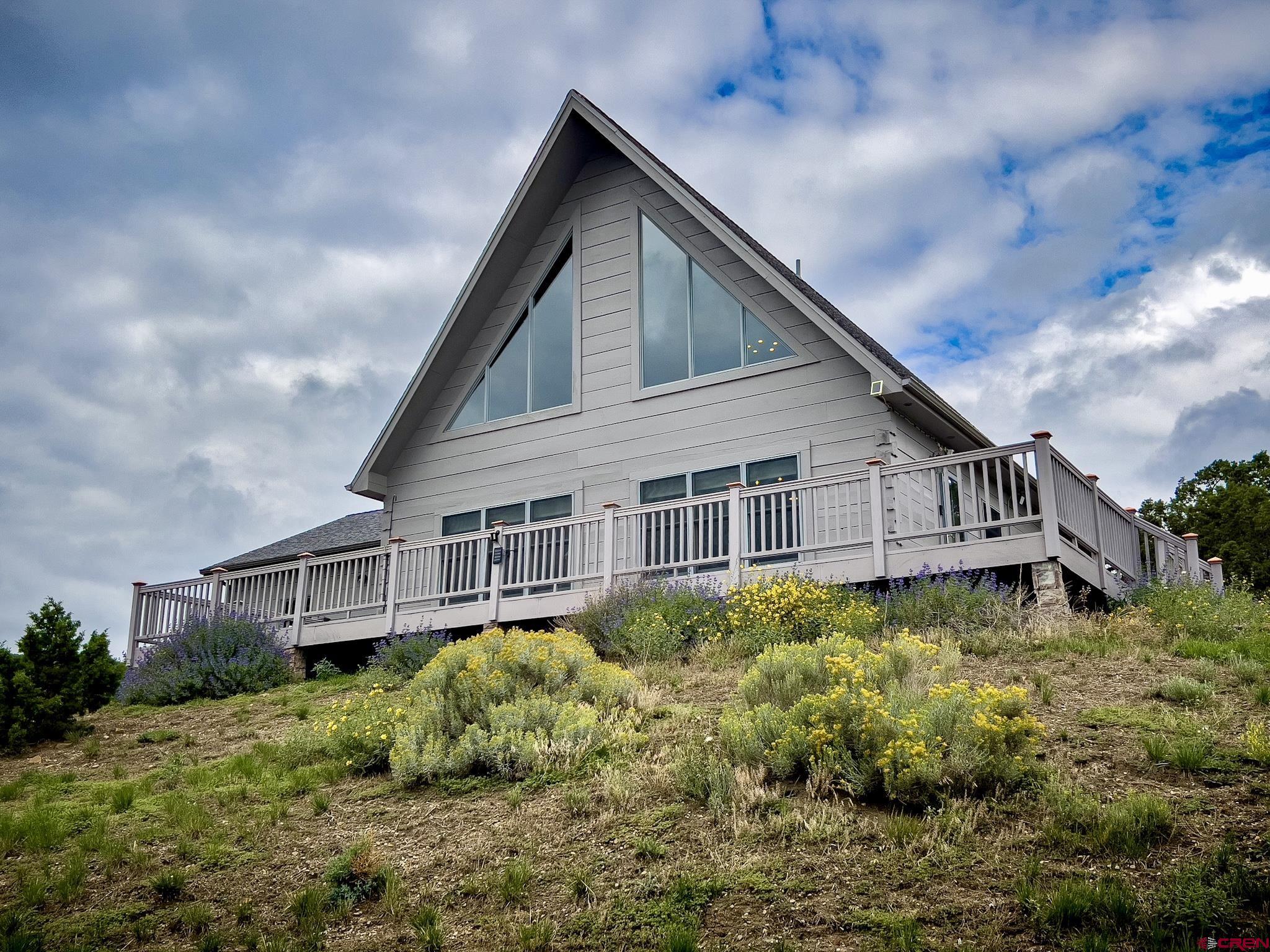 a view of a house with wooden fence