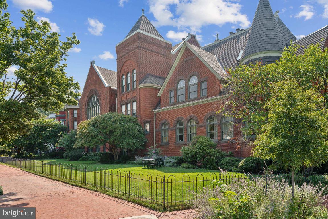 a view of a brick building next to a yard