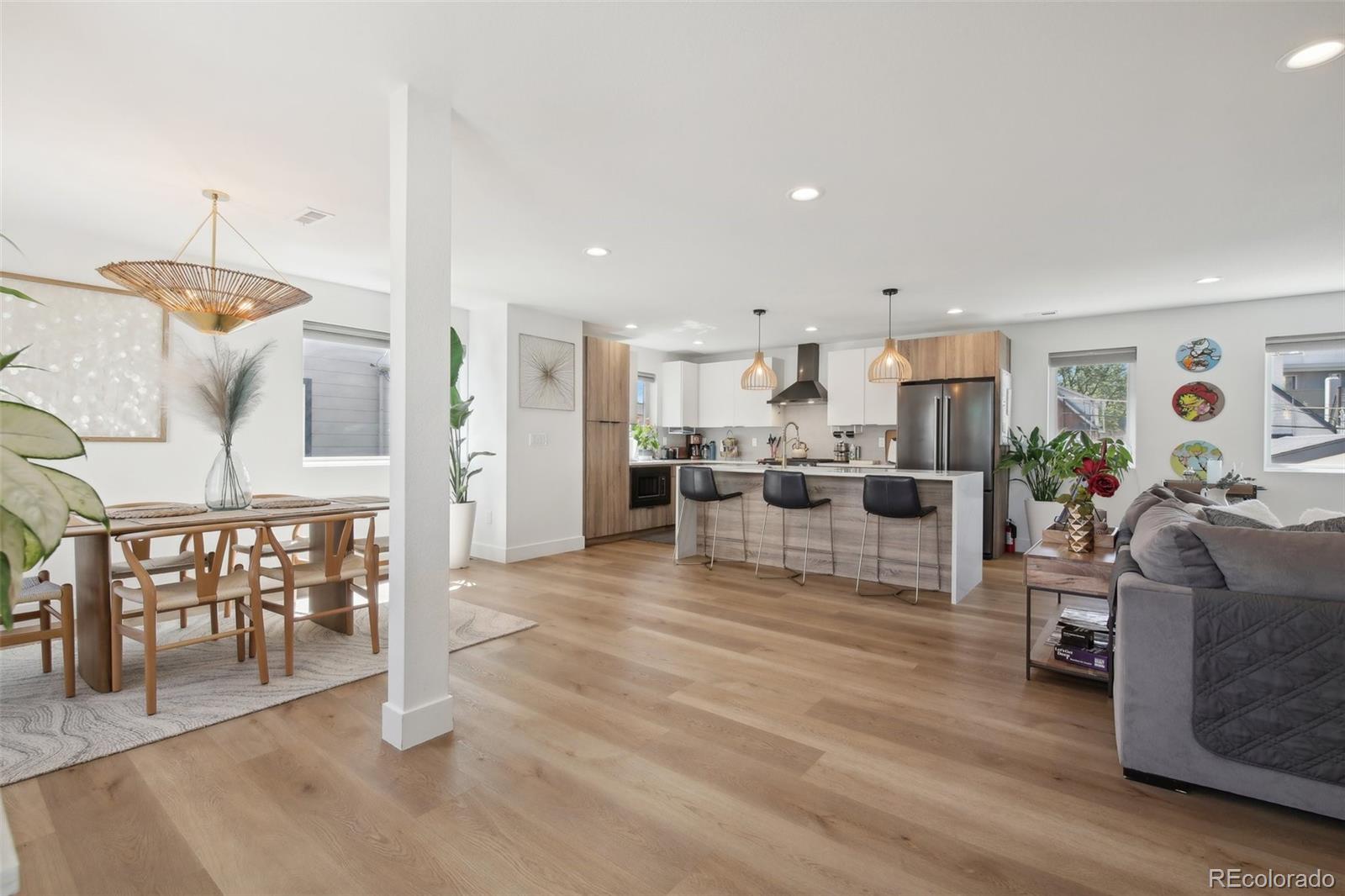 a living room with furniture and kitchen view