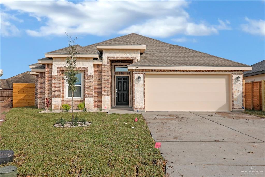 View of front facade with a front lawn and a garage