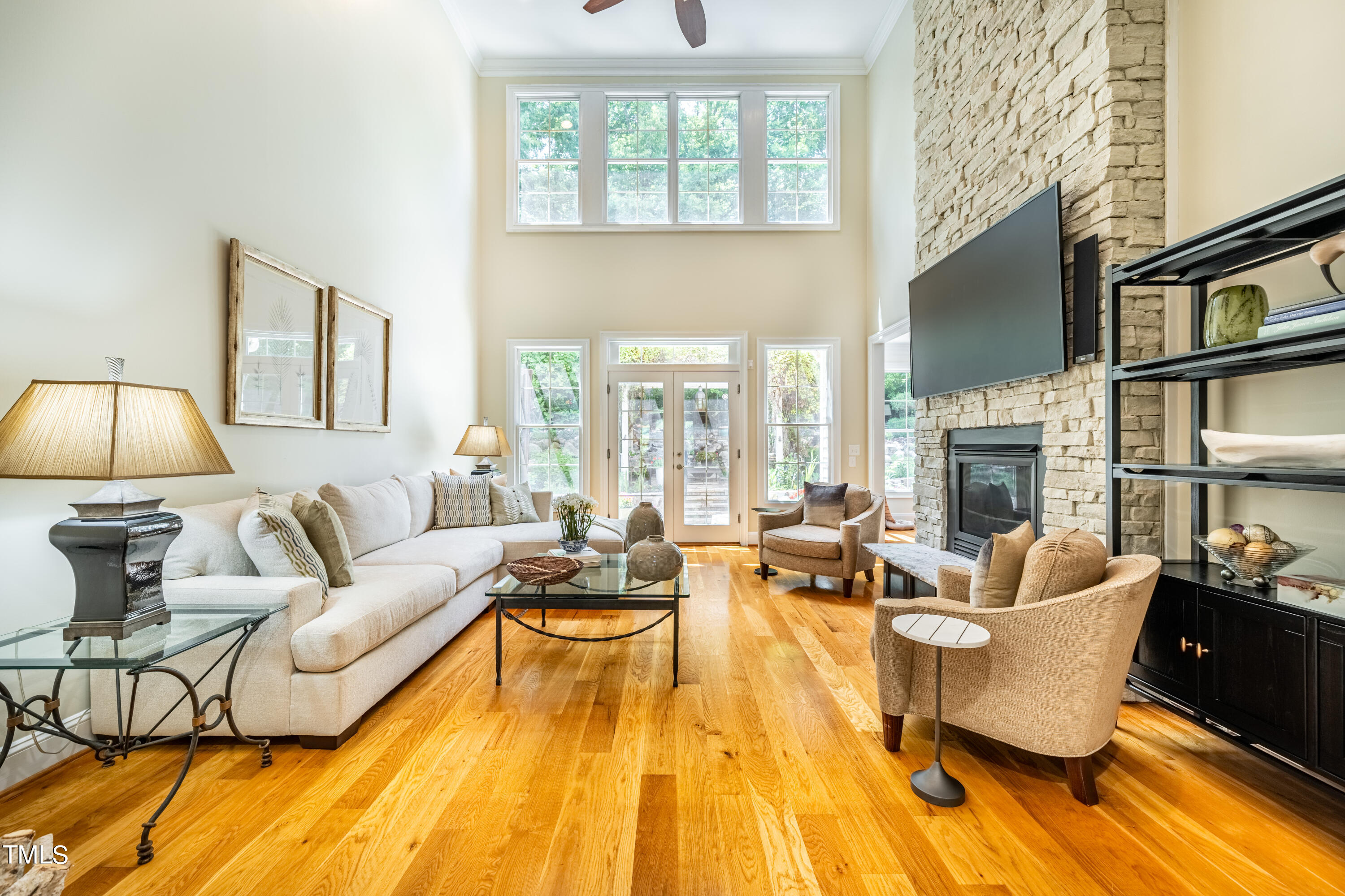 a living room with fireplace furniture and a chandelier