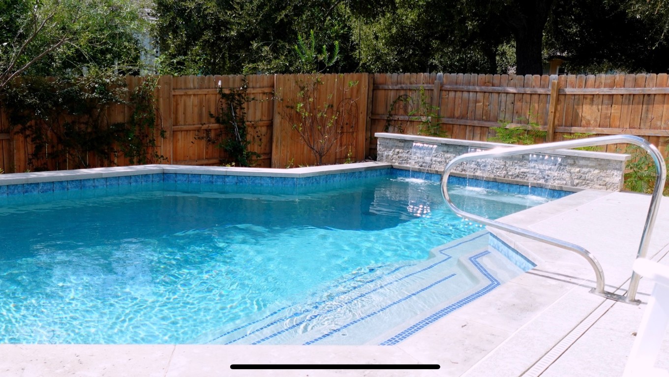 a view of backyard with swimming pool and outdoor seating