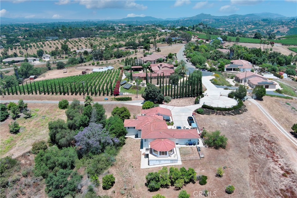 an aerial view of a house with a yard and lake view