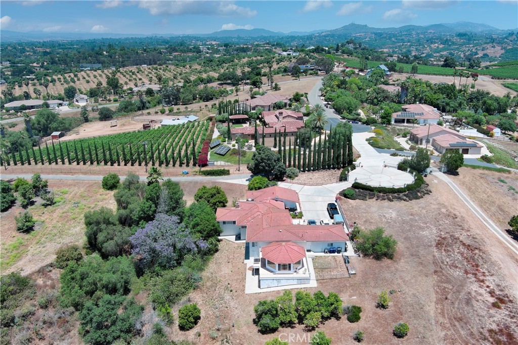 an aerial view of a house with a yard and lake view