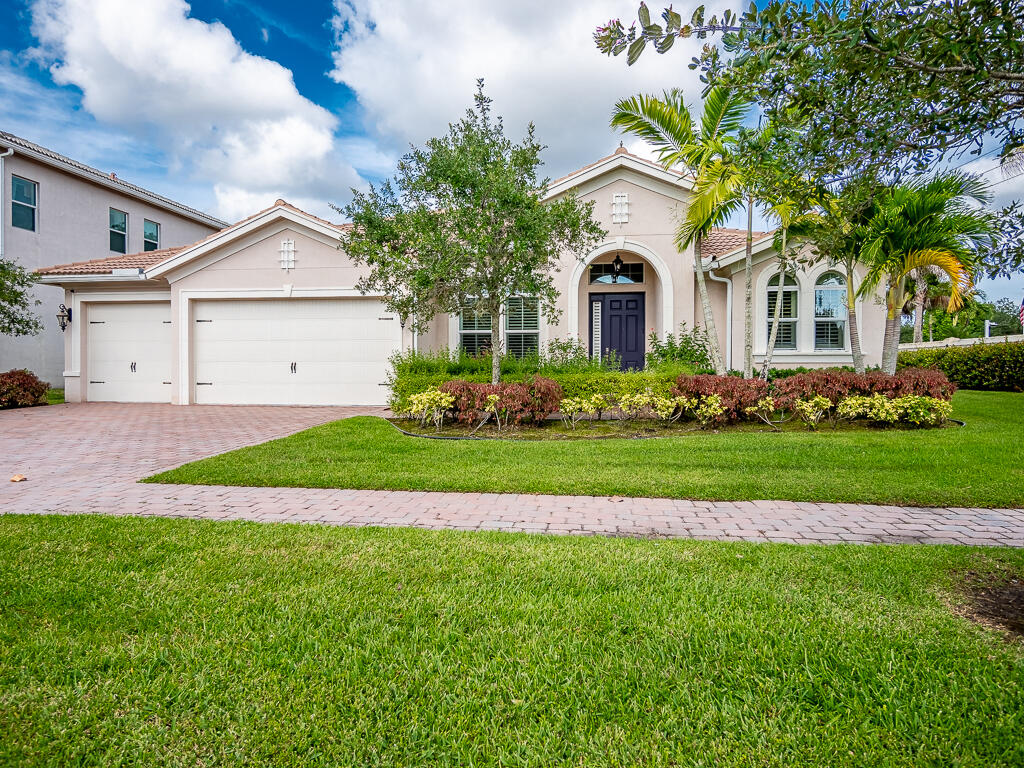 a front view of a house with a garden and plants