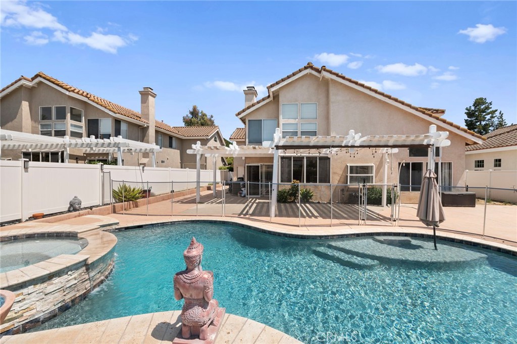 a front view of a house with swimming pool having outdoor seating