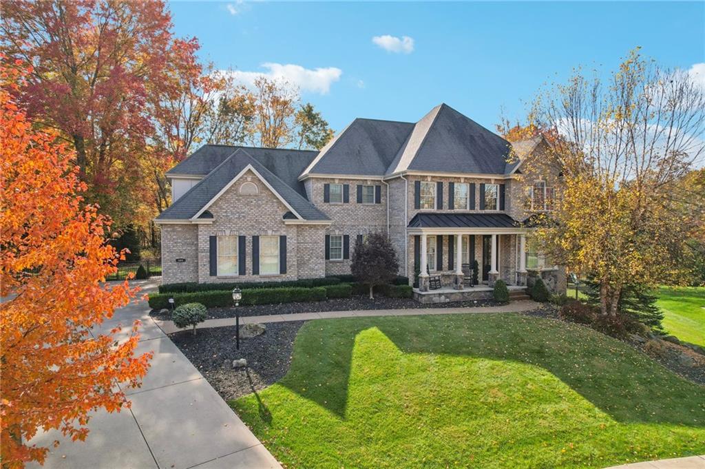 a front view of a house with yard patio and green space