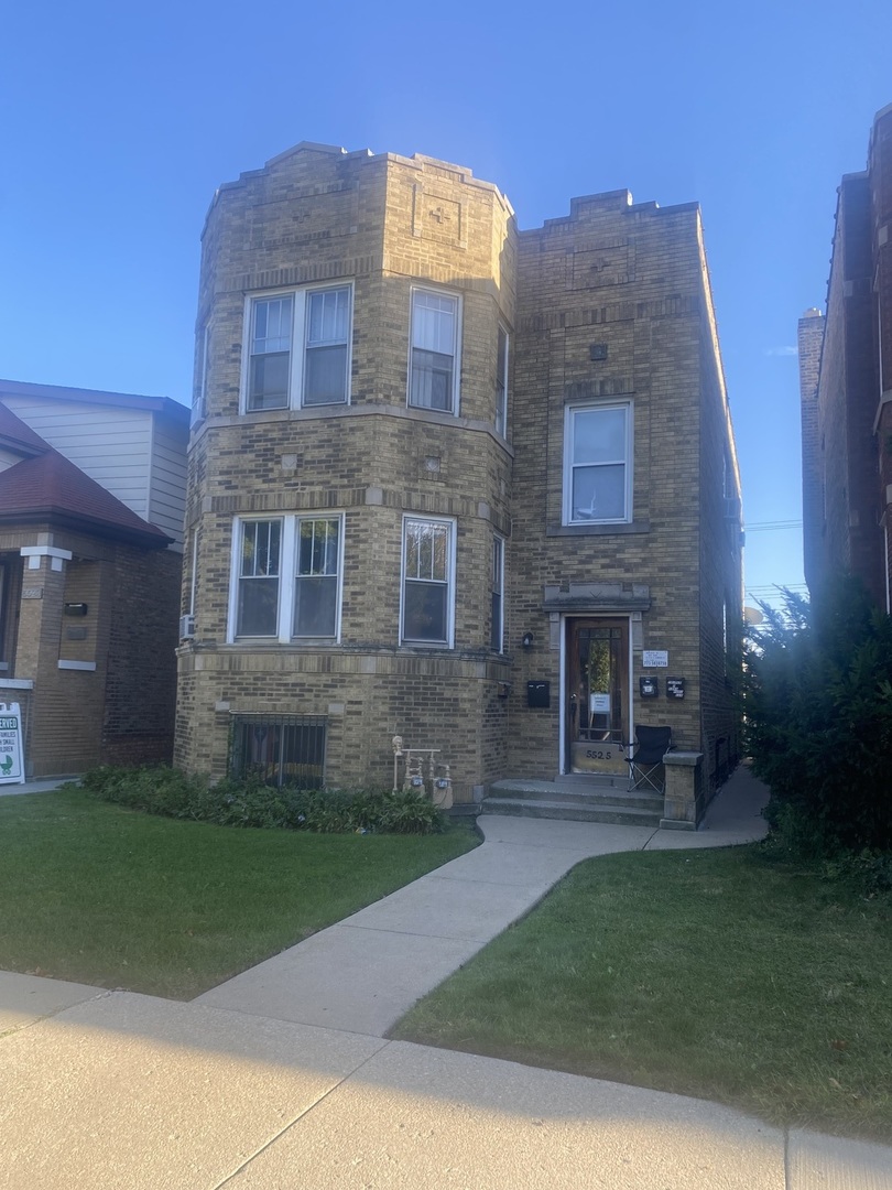 a brick building with a yard in front of it