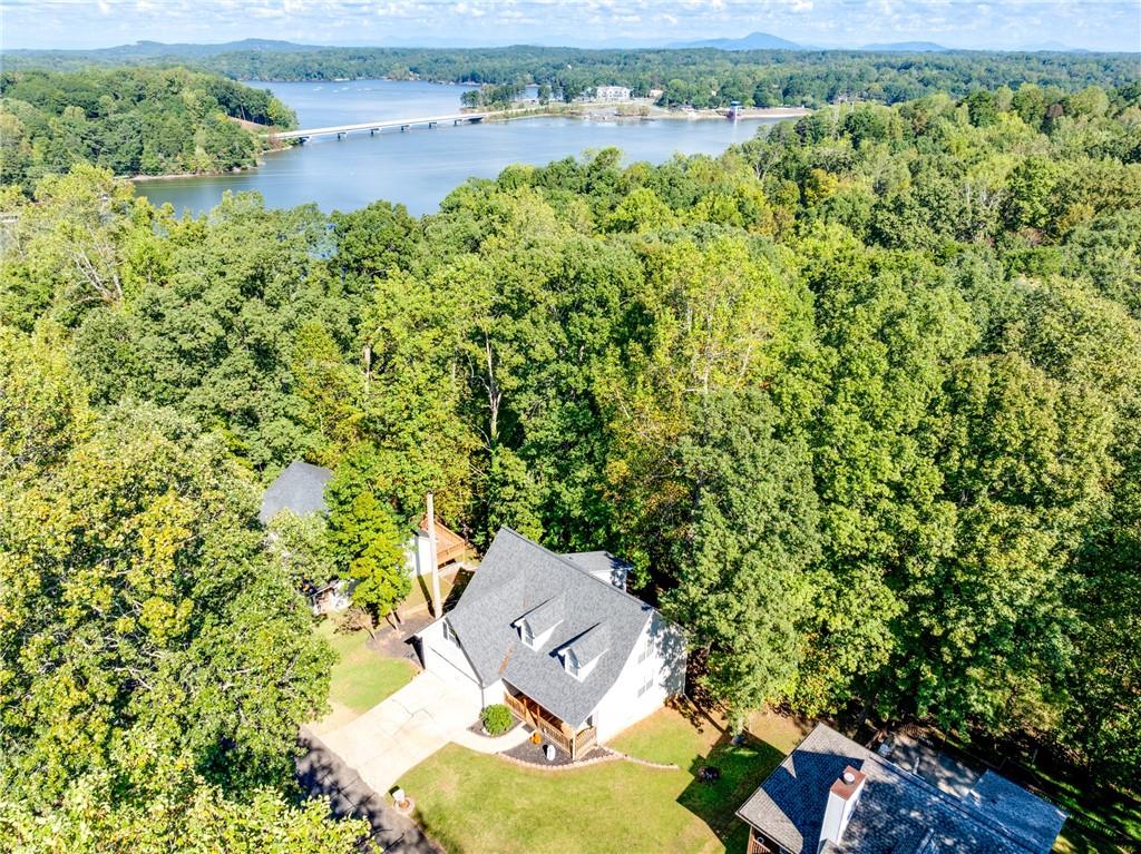 an aerial view of a house with a garden and lake view