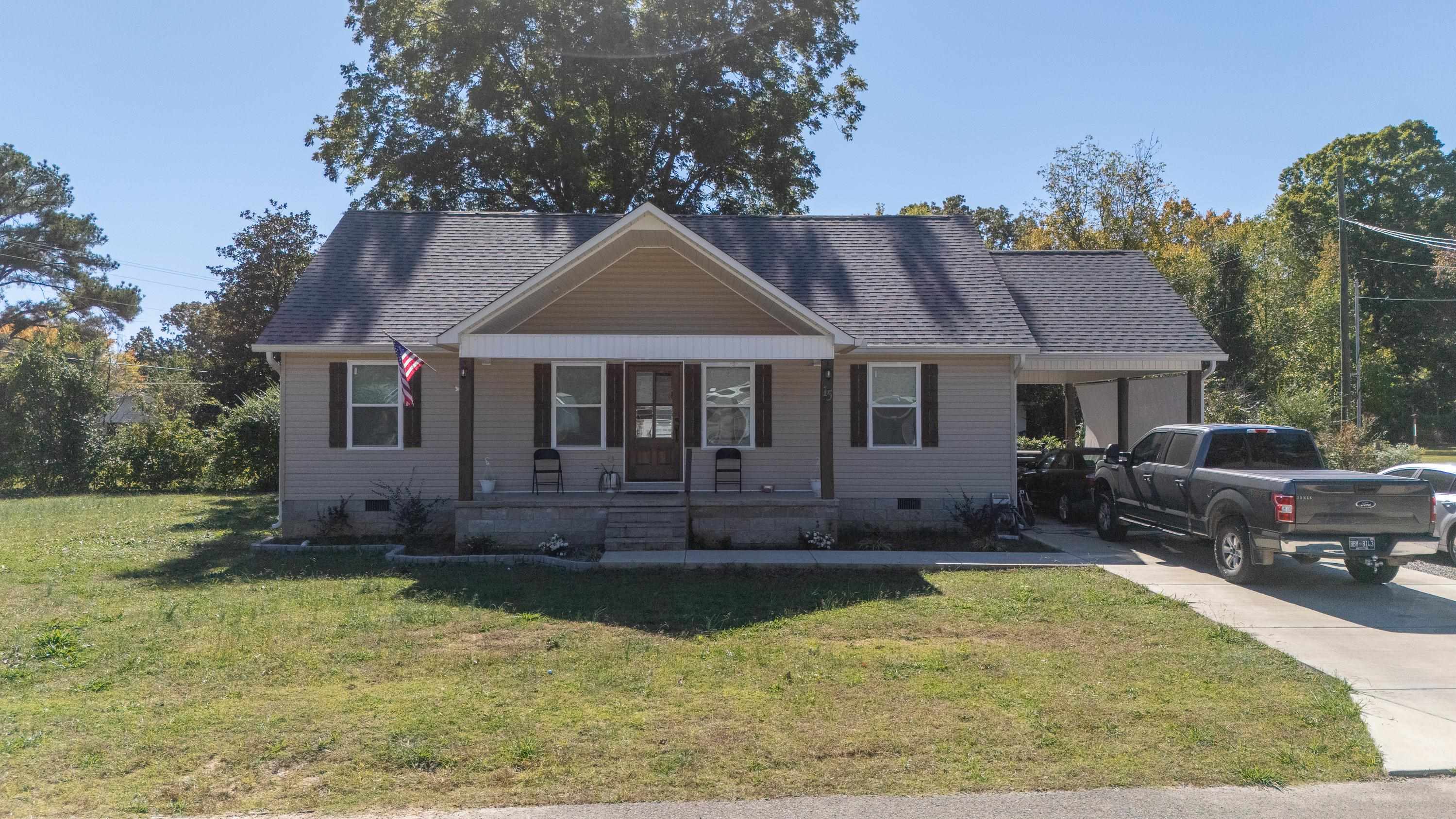 a front view of a house with a yard table and chairs