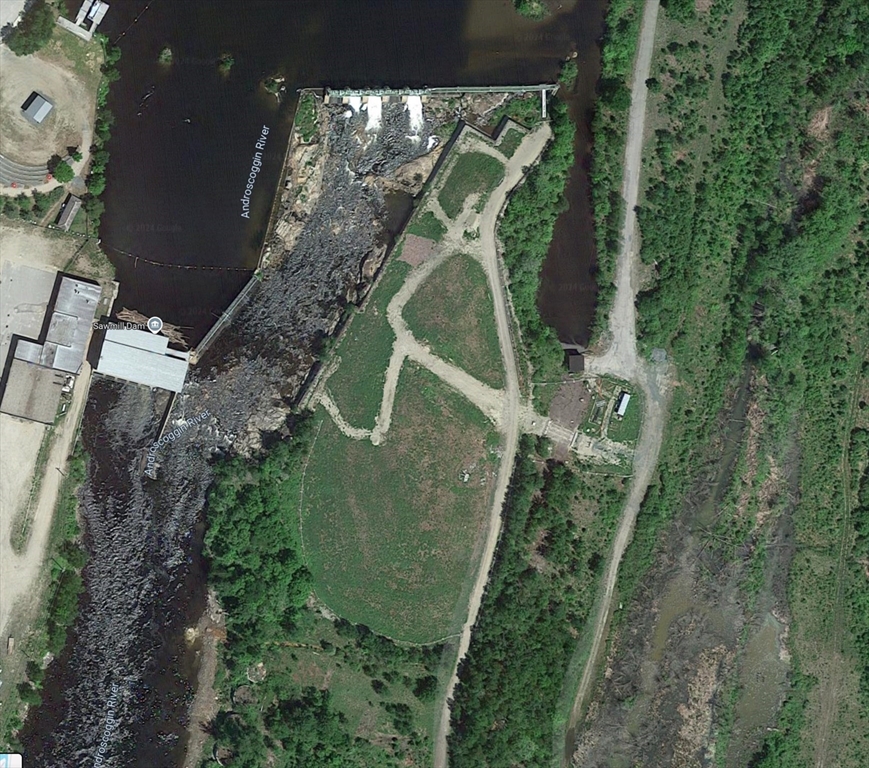 an aerial view of a house with a yard and trees