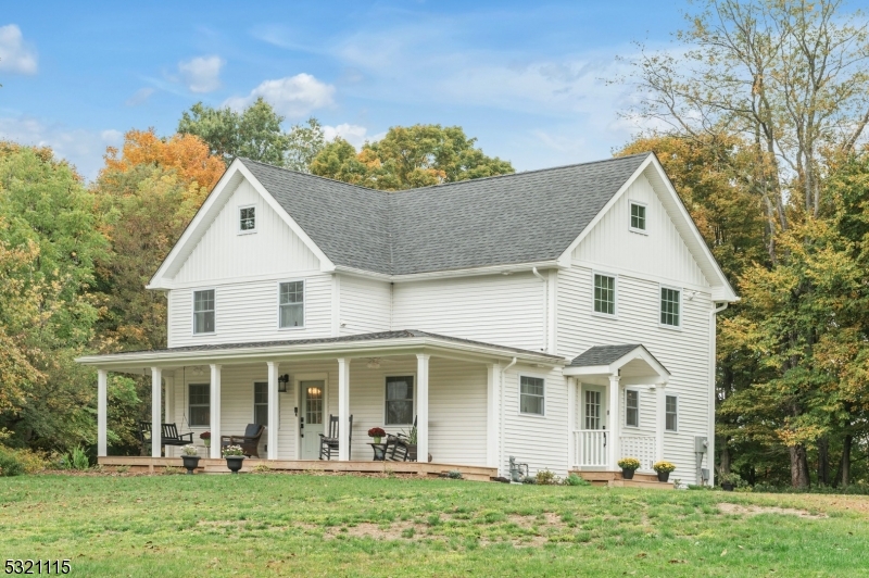 a view of a white house with yard and plants