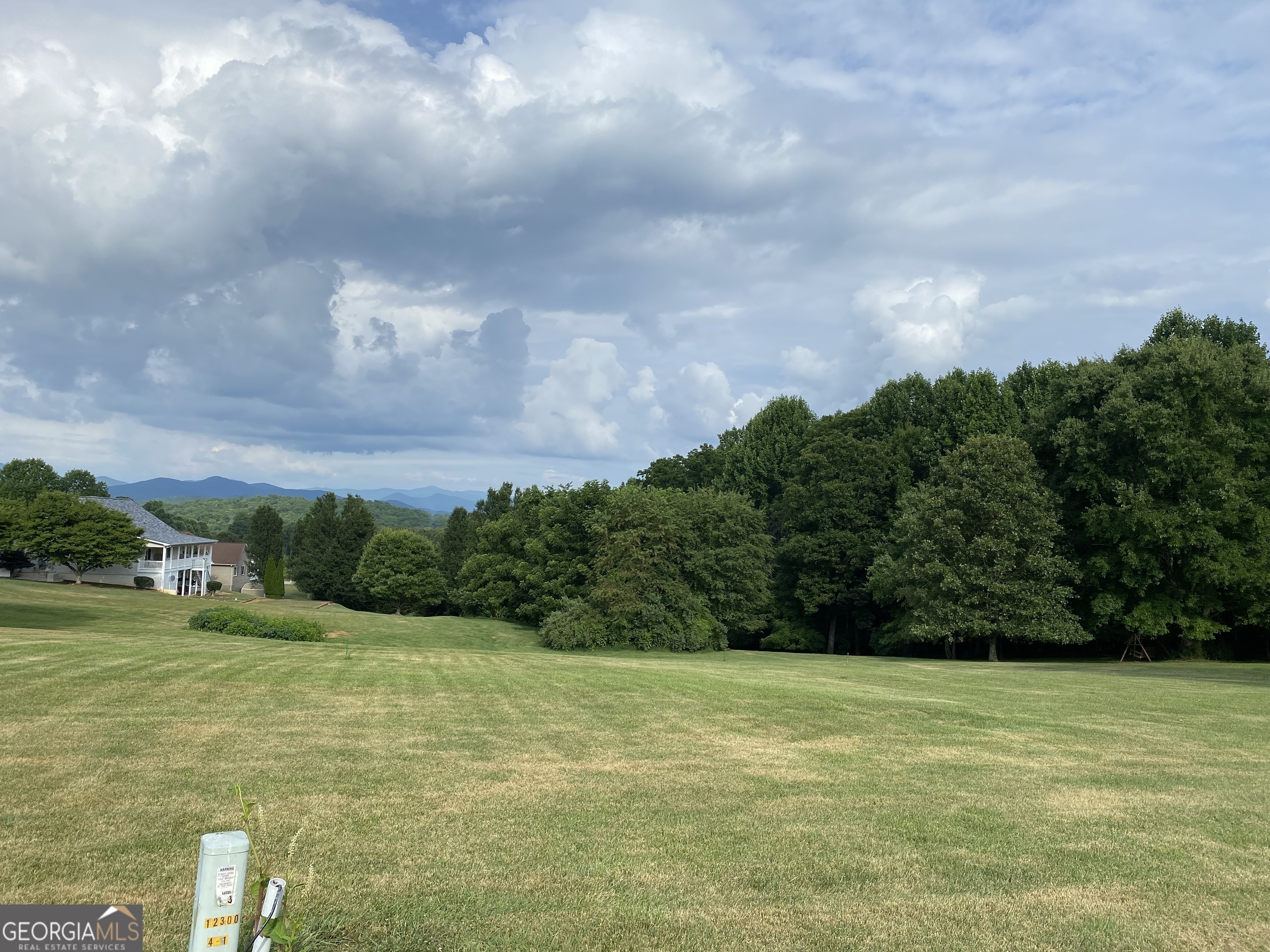 a view of a lake with a yard