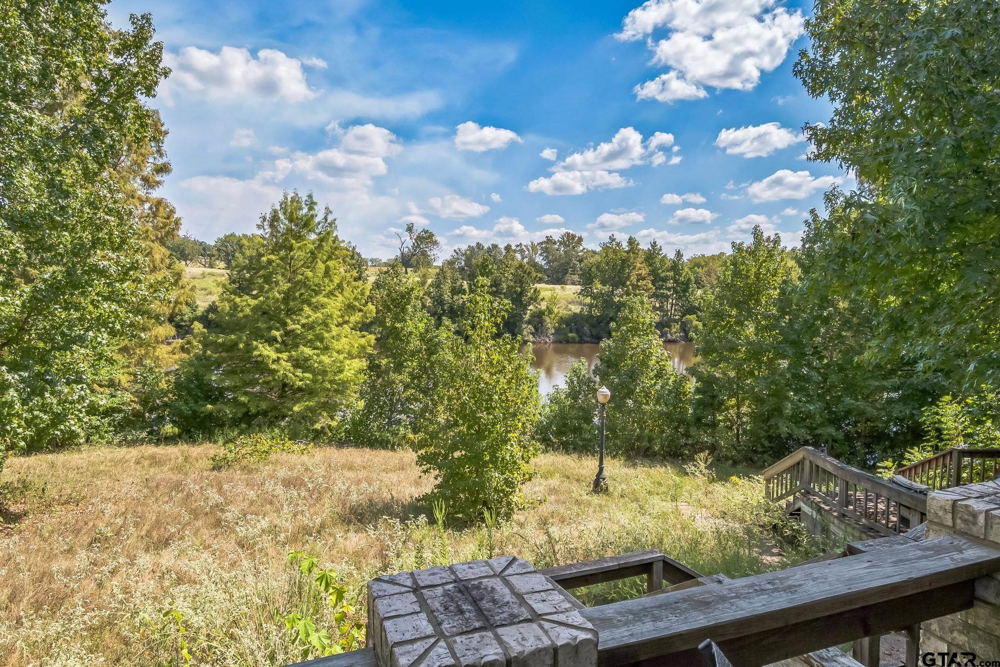 a view of a yard with wooden fence