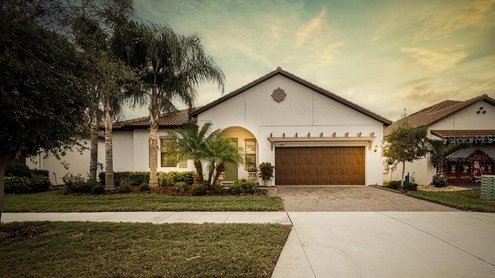 a front view of a house with a yard and garage