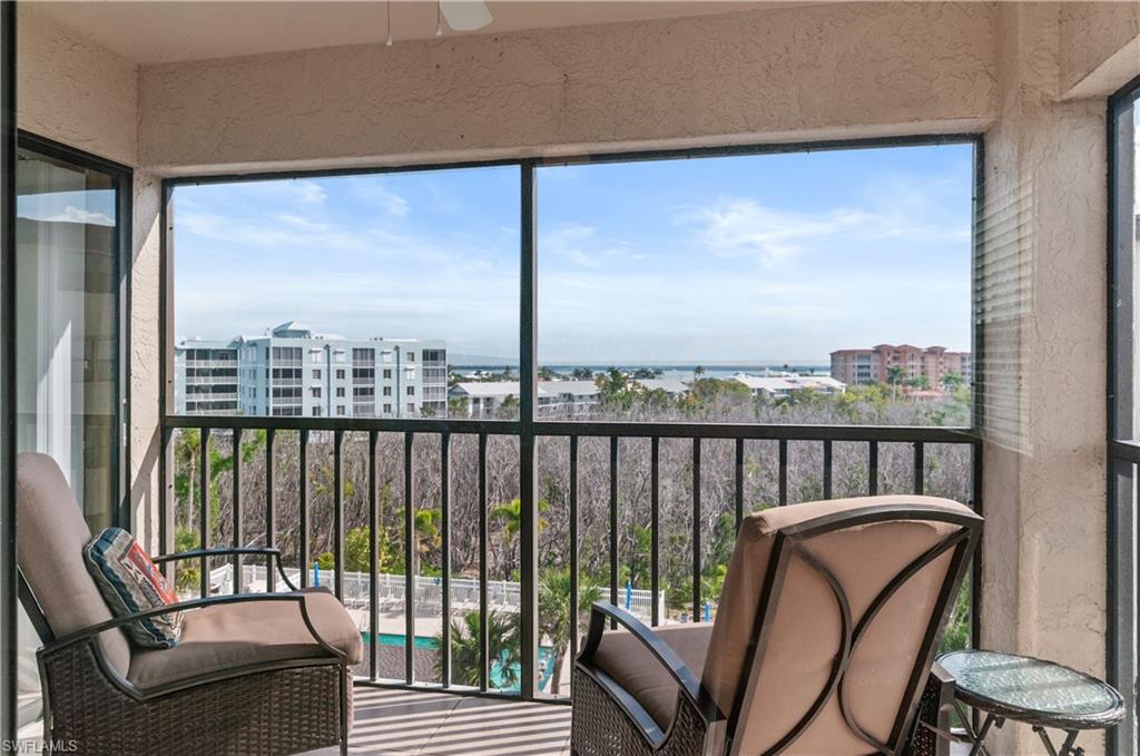 a view of a balcony with furniture