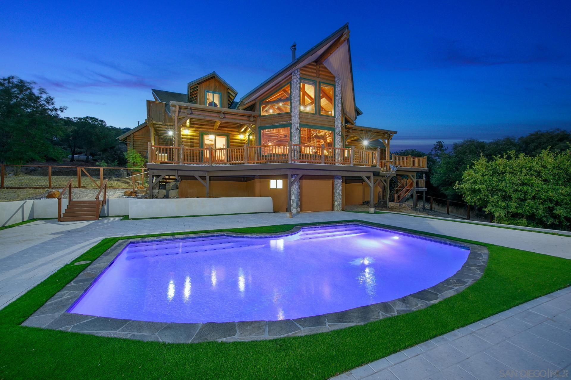 a view of a big yard with a house in the background