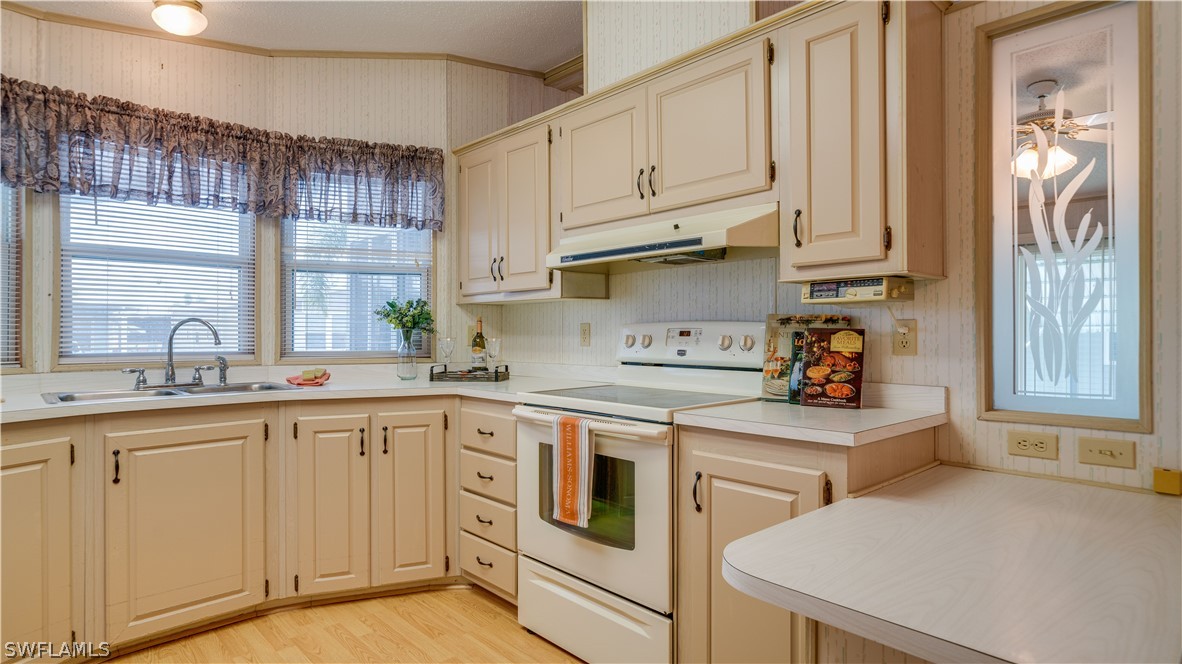 a kitchen with white cabinets and white appliances