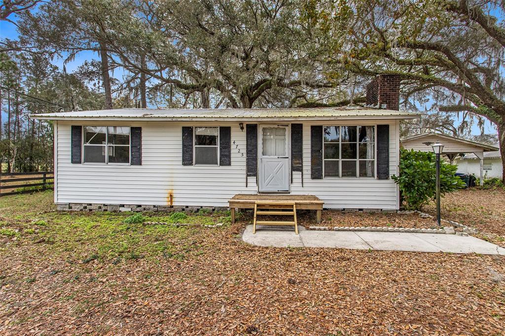 a house with trees in the background