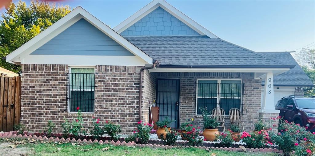 a front view of a house with a yard and plants