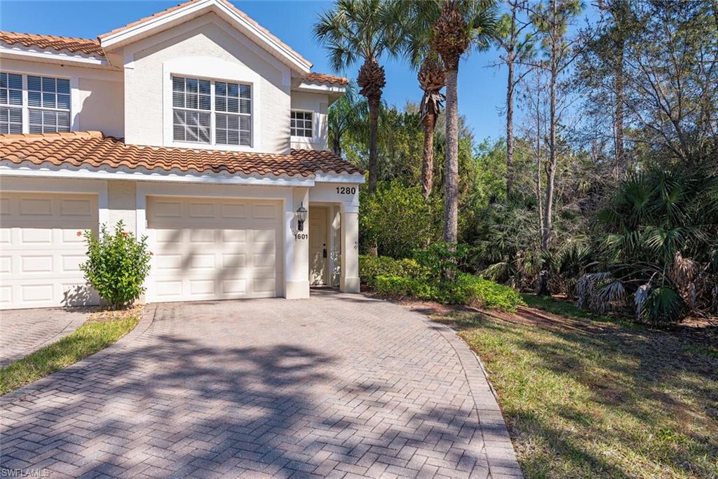 Mediterranean / spanish-style home with a garage