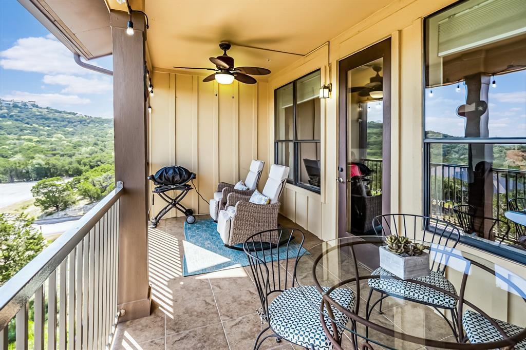 a balcony view with a couch and wooden floor