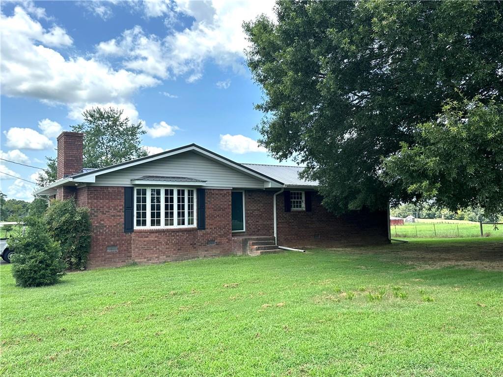 a front view of house with yard and green space