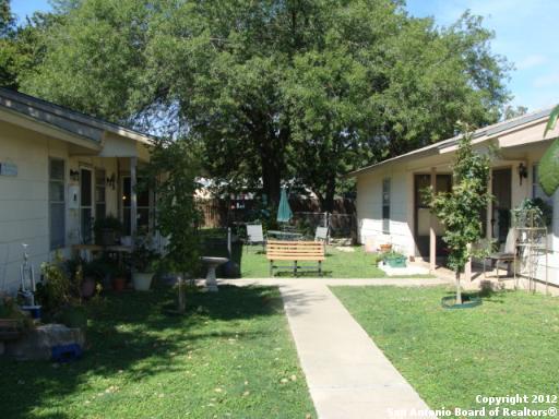 a view of a house with backyard sitting area and garden