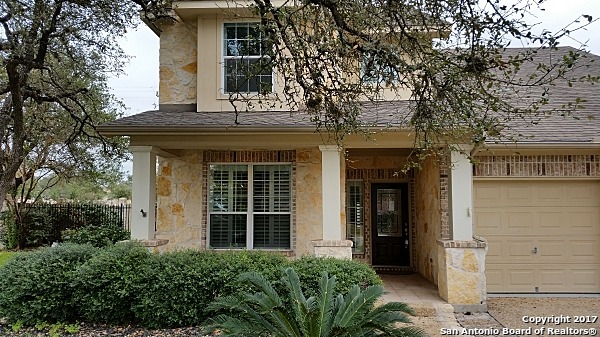 front view of a brick house with a large window