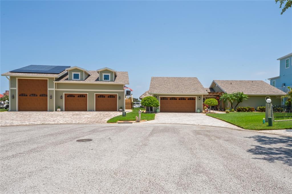 a front view of a house with a garden and parking space