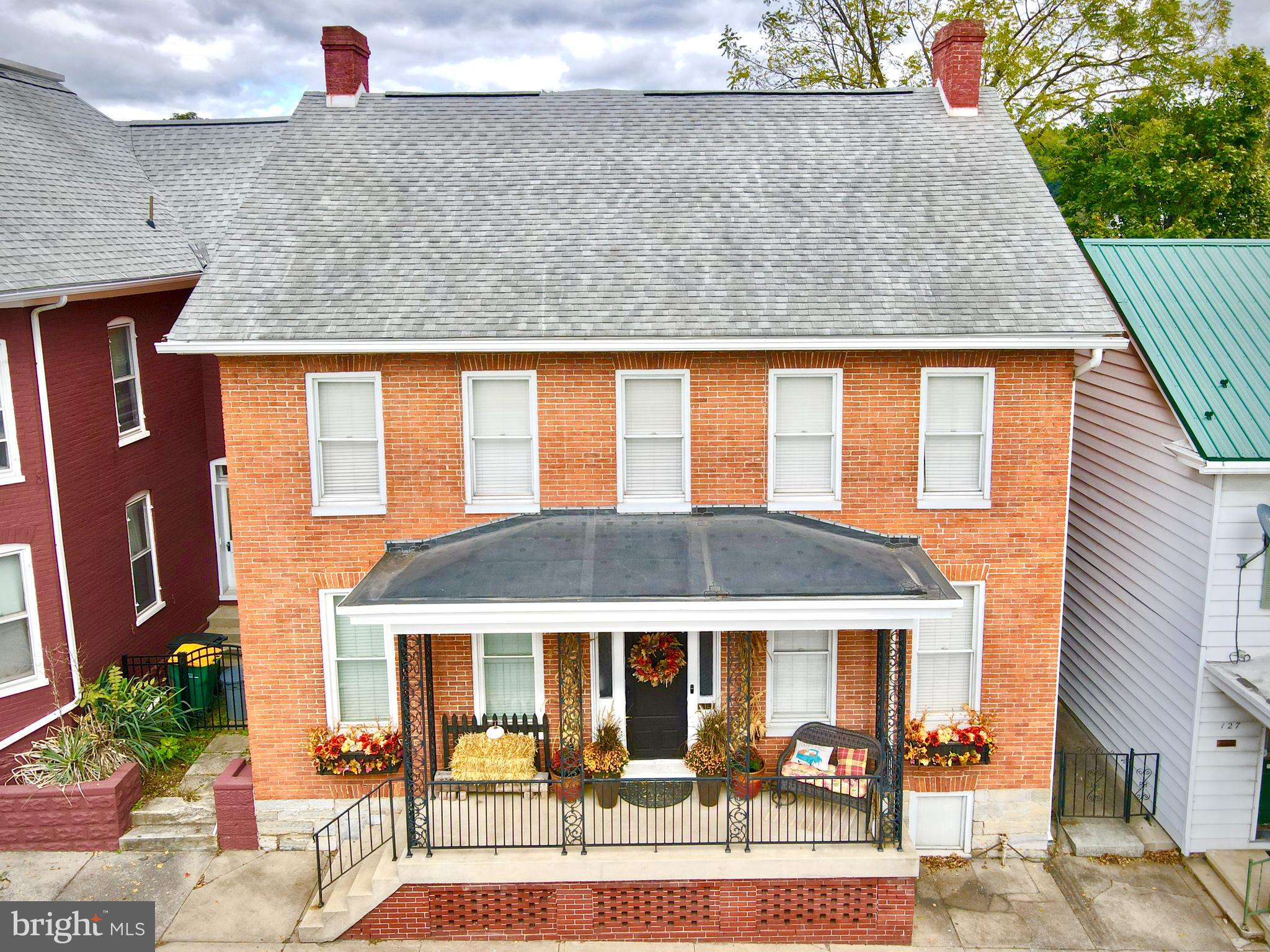 a front view of a house with glass windows and couches