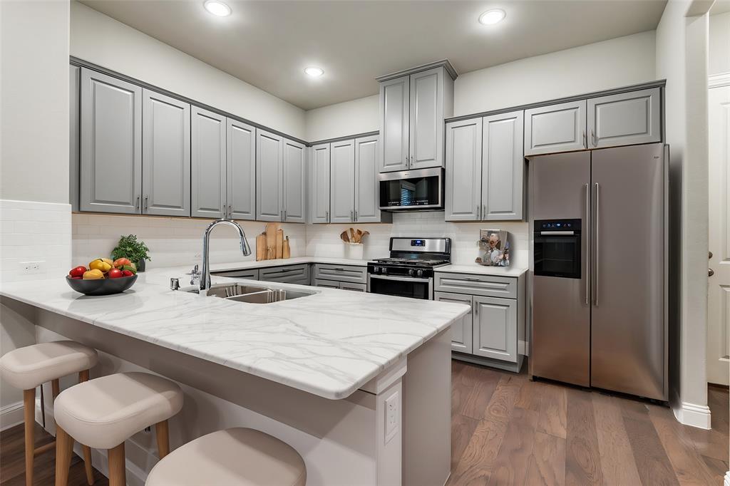 a kitchen with a refrigerator a stove a sink and a cabinets