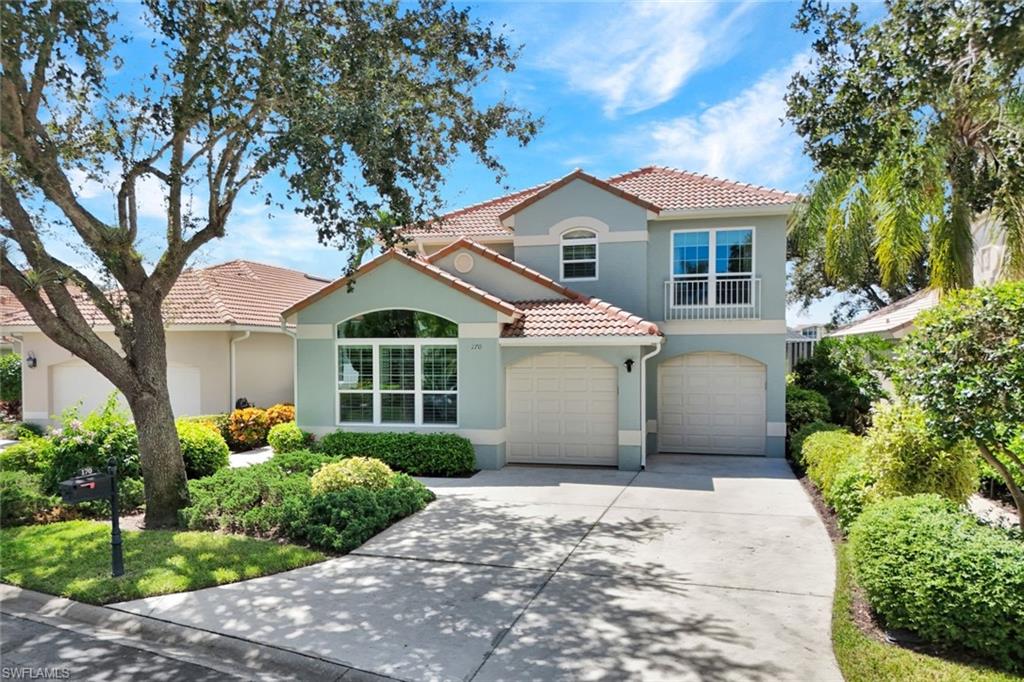 Mediterranean / spanish-style home with a garage