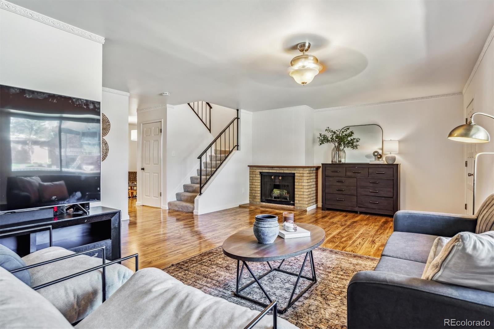 a living room with furniture and a chandelier