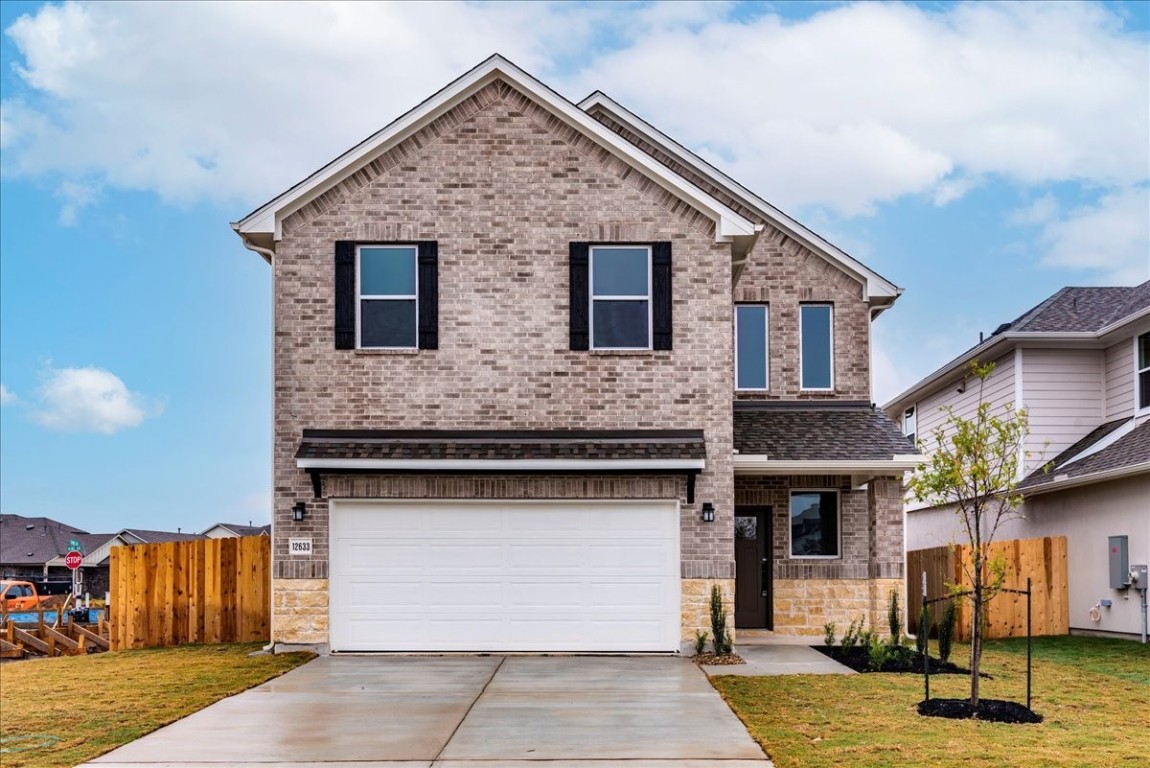 a front view of a house with garage