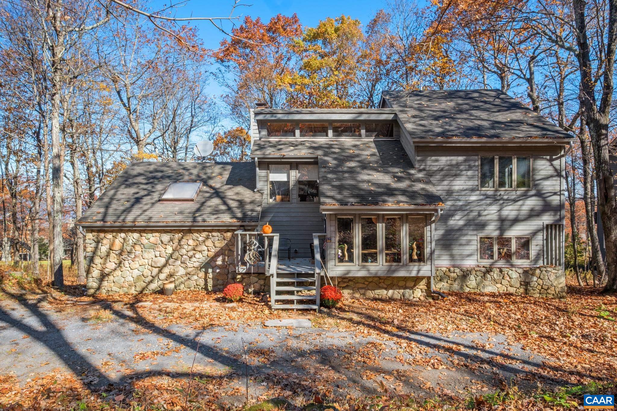 front view of a house with a large tree