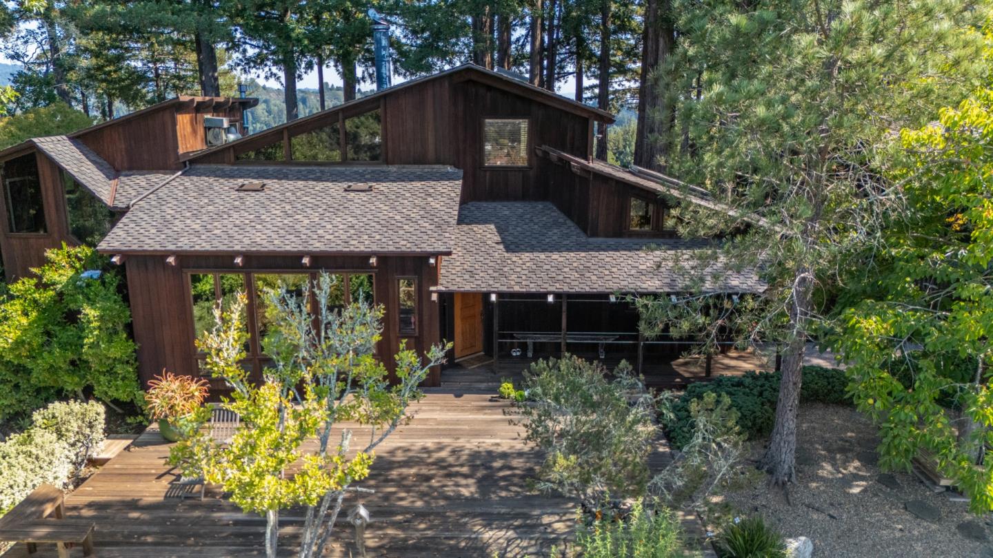 a front view of house with trees in the background