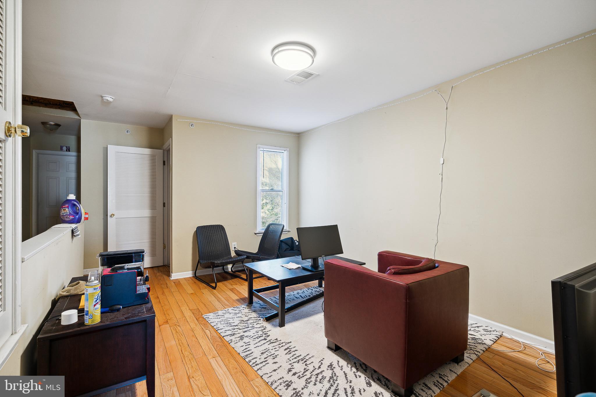 a living room with furniture and a mirror