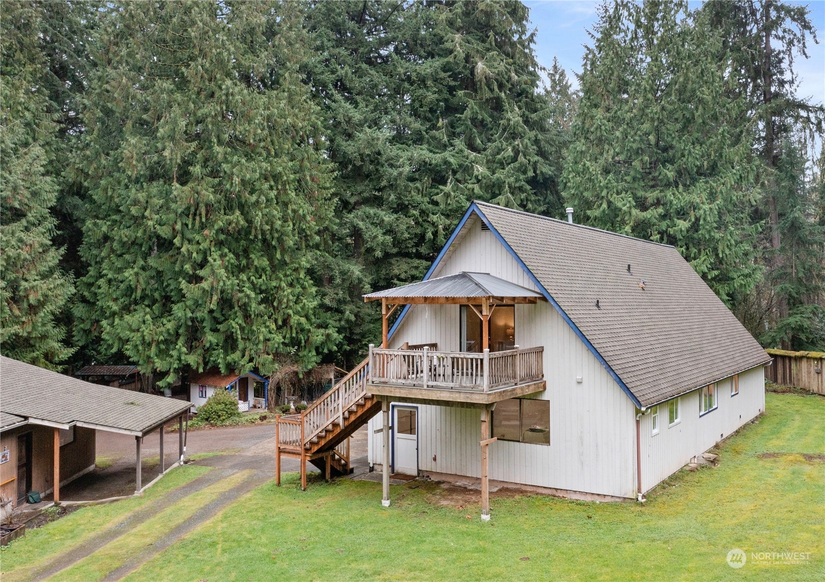 a aerial view of a house with a yard table and chairs