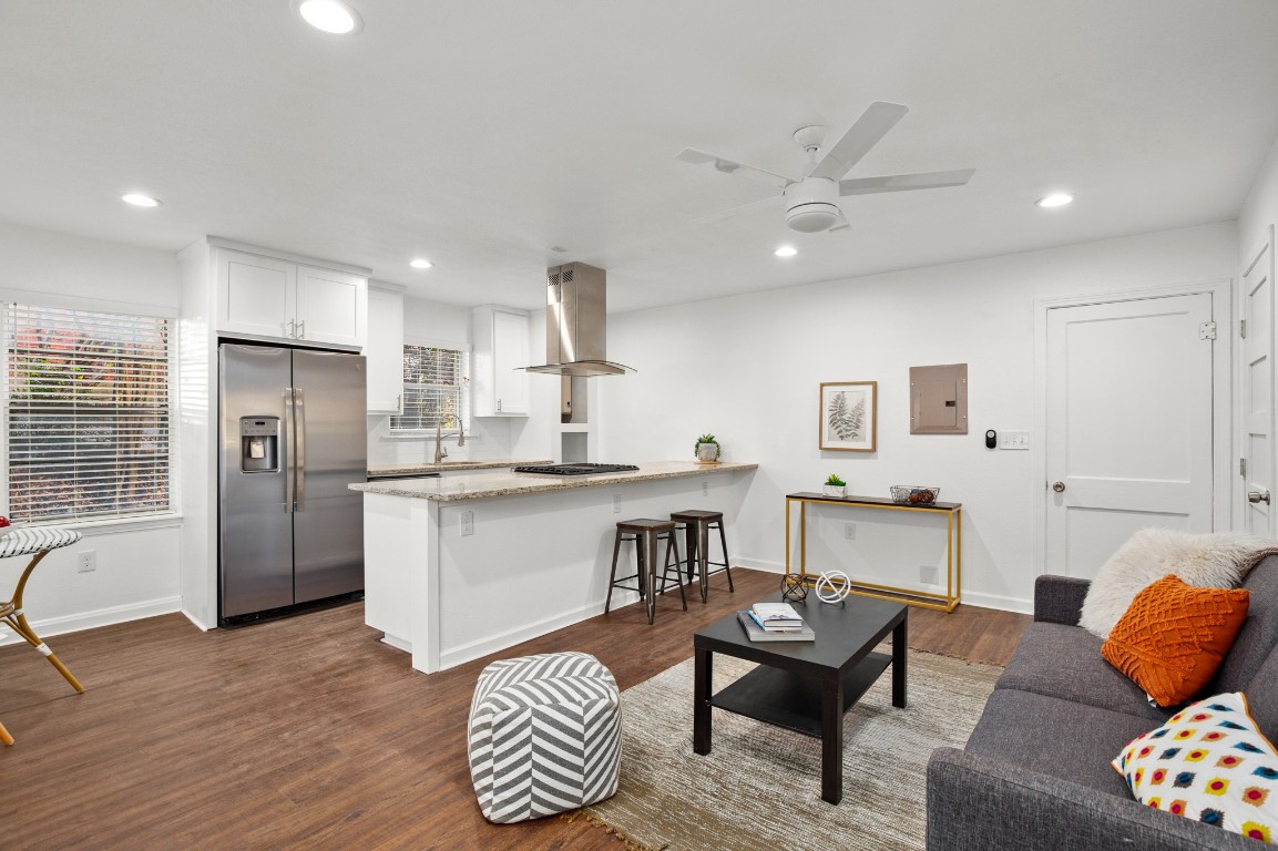 a living room with furniture and kitchen view