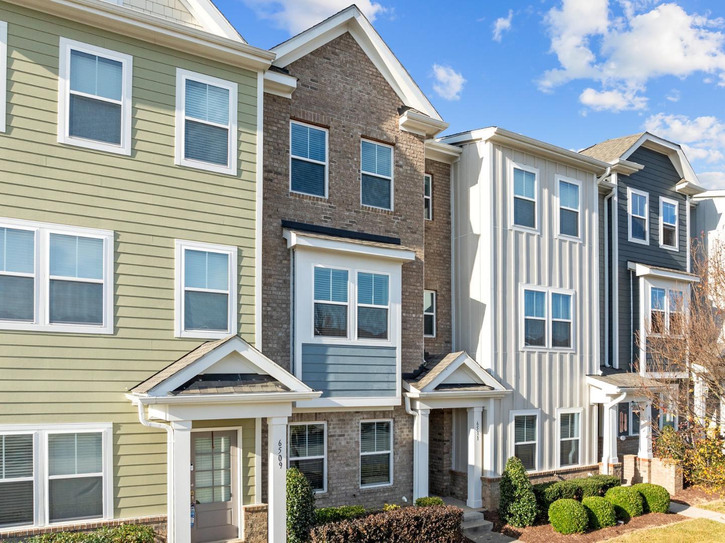 a front view of a residential apartment building with a yard