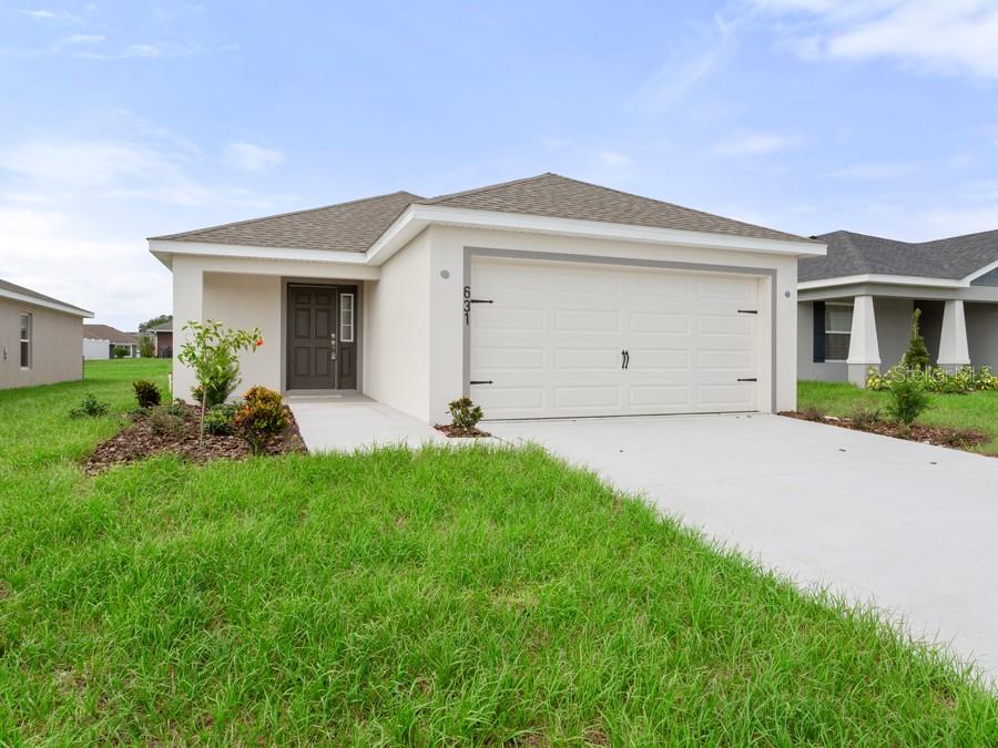 a front view of a house with a yard and garage