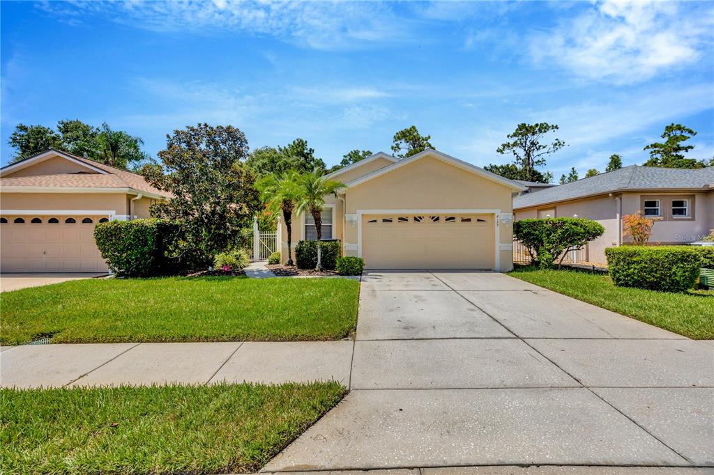 a front view of a house with a yard and garage