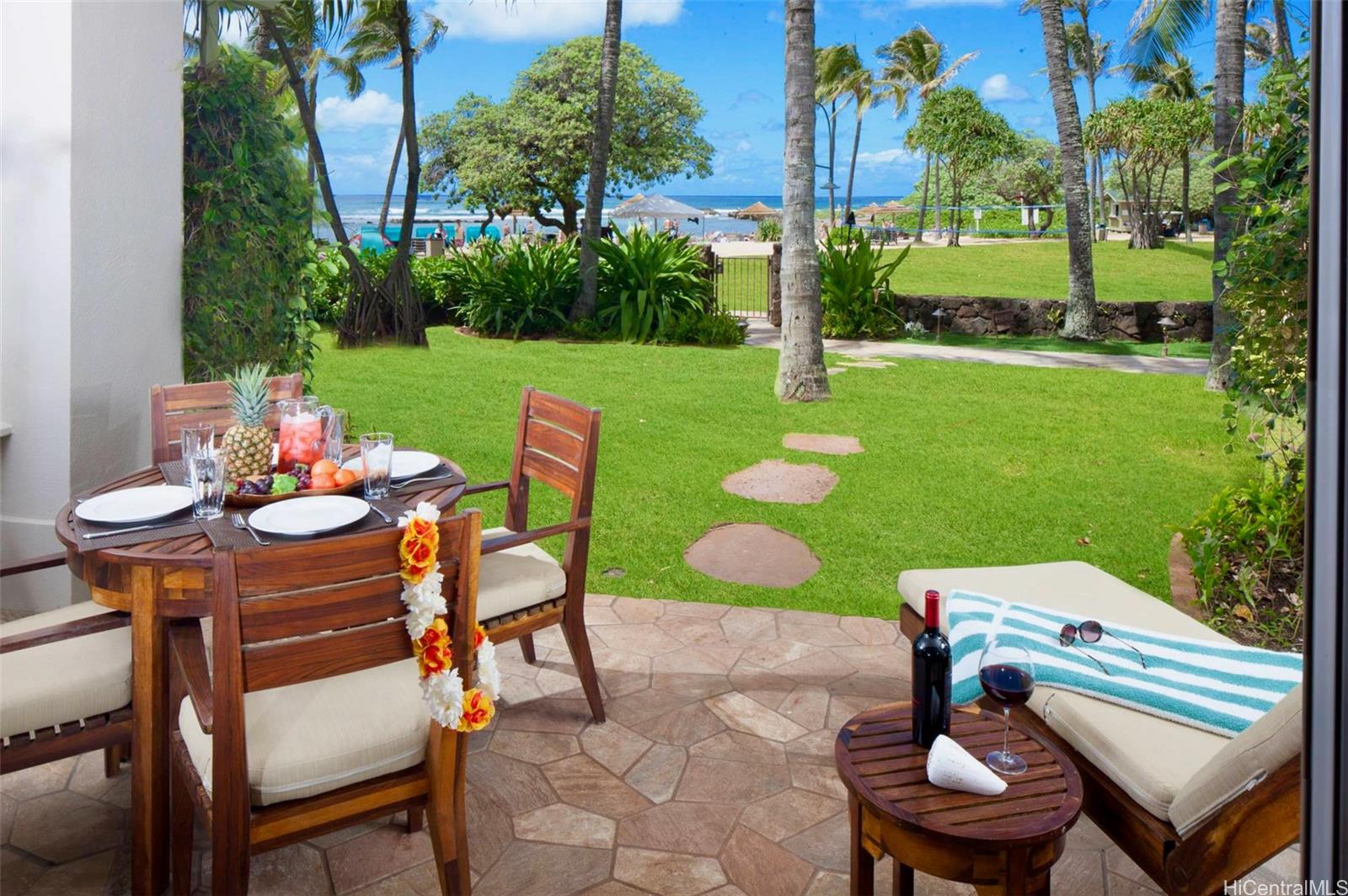 a backyard of a house with table and chairs plants and large trees