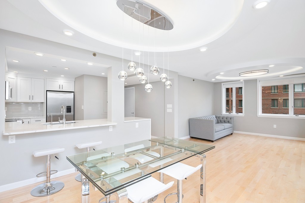 a living room with kitchen island furniture and a chandelier