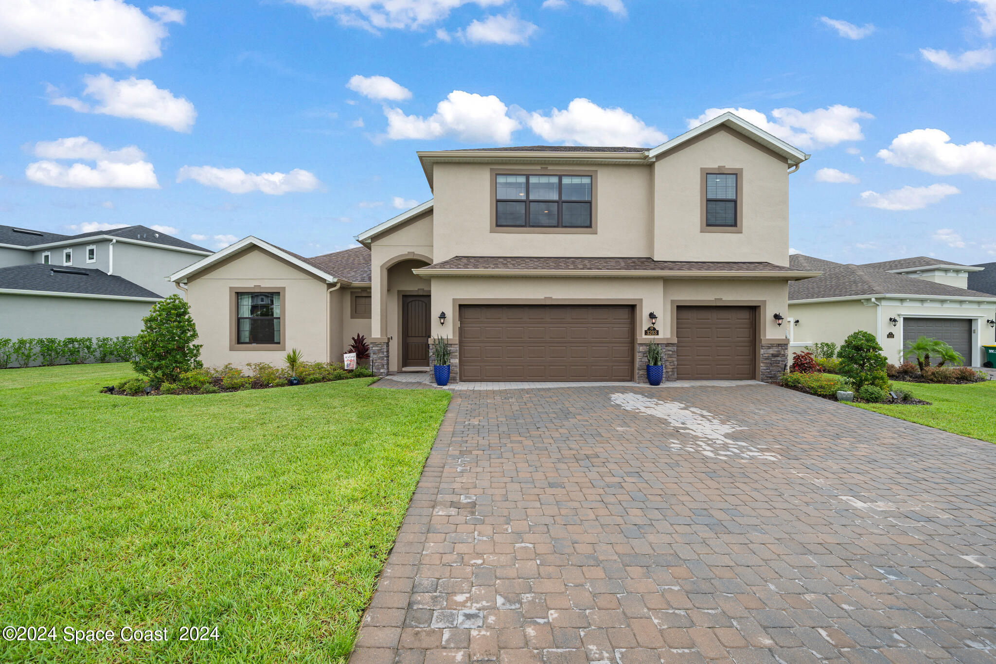 a front view of a house with a yard and garage